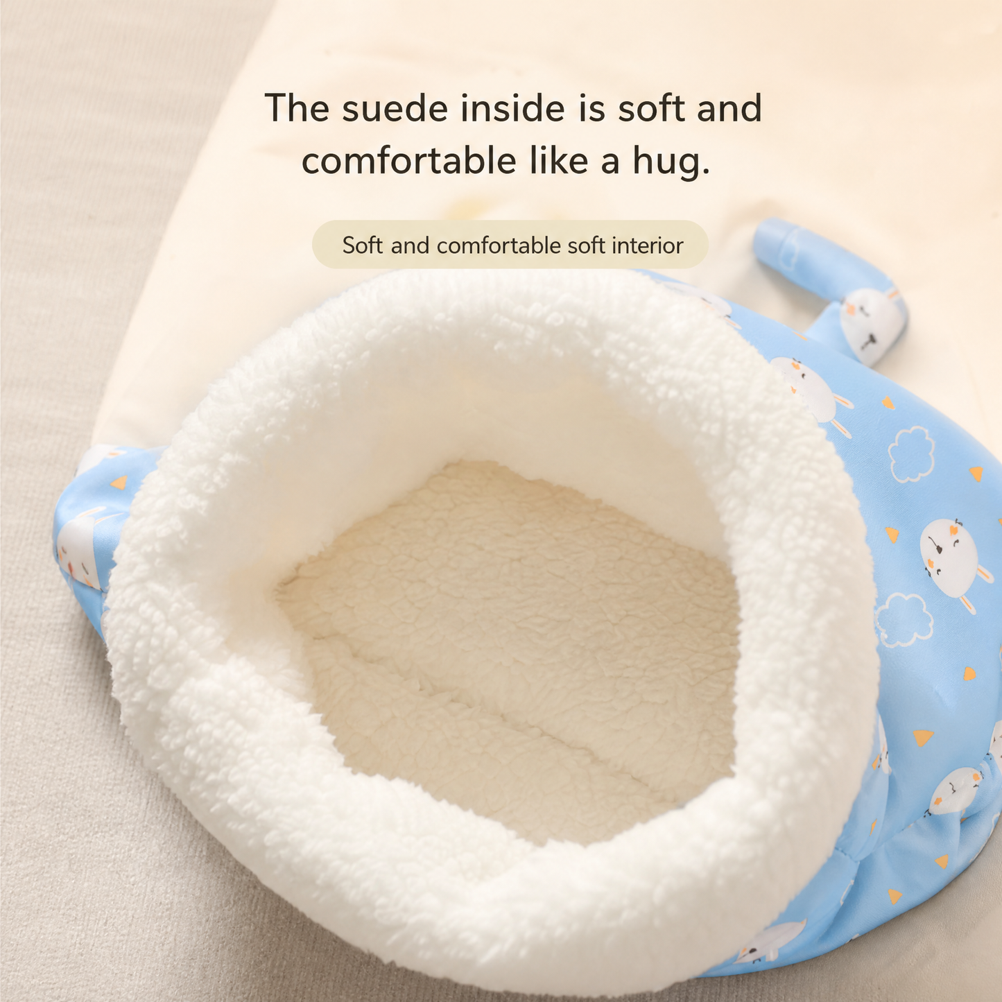 Close-up of the pet sleeping bag's cream-colored plush lining and padded opening