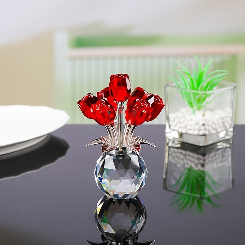Red crystal rose ornament displayed on a reflective tabletop