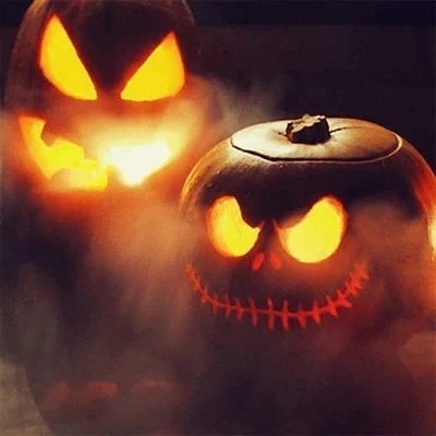 Halloween pumpkins surrounded by atmospheric mist from a decorative fog effect