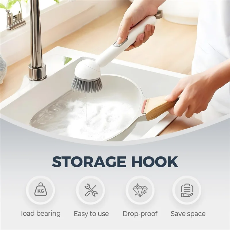 Soap dispensing dish brush being used over a pan with a long handle and integrated soap dispensing button