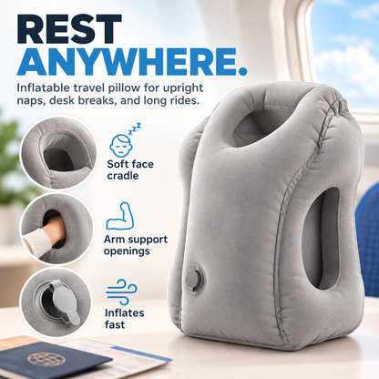 Gray inflatable face-down travel pillow with cushioned face opening, side arm openings and inflation valve