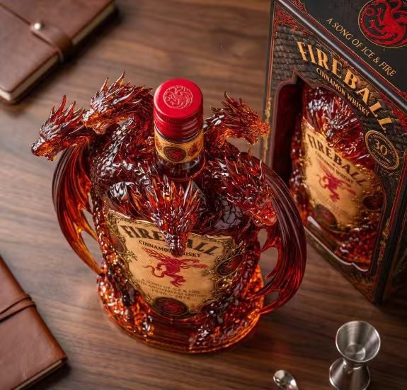 Top view of sculpted dragon collector bottle showing layered heads and wings
