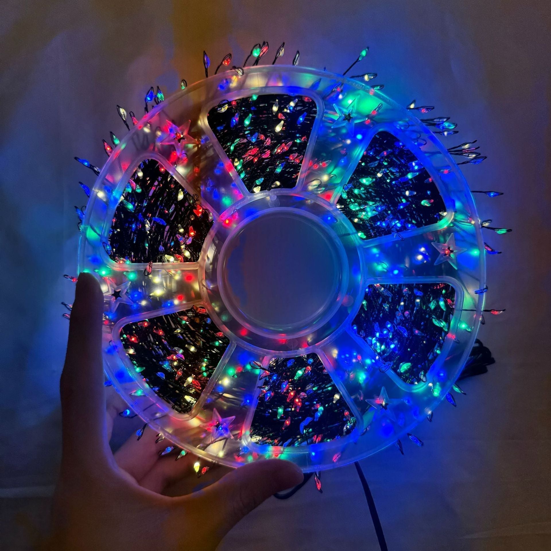 Multicolor LED string lights arranged on a clear reel