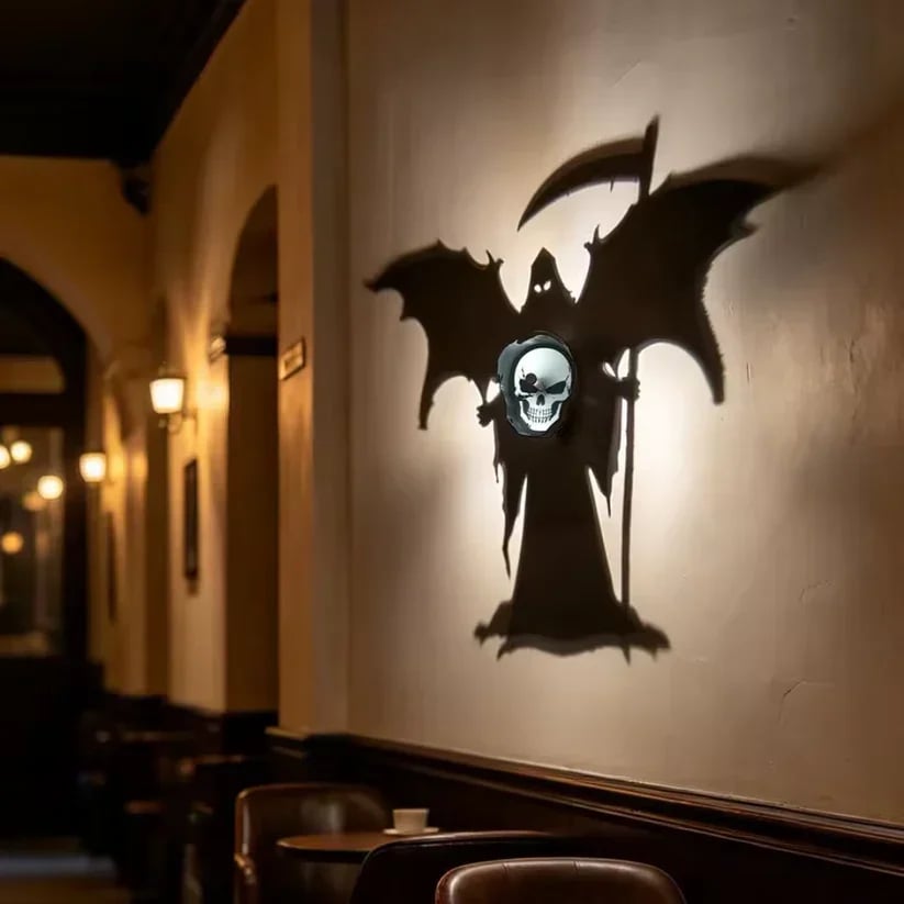 Winged Grim Reaper shadow displayed on an interior wall above seating