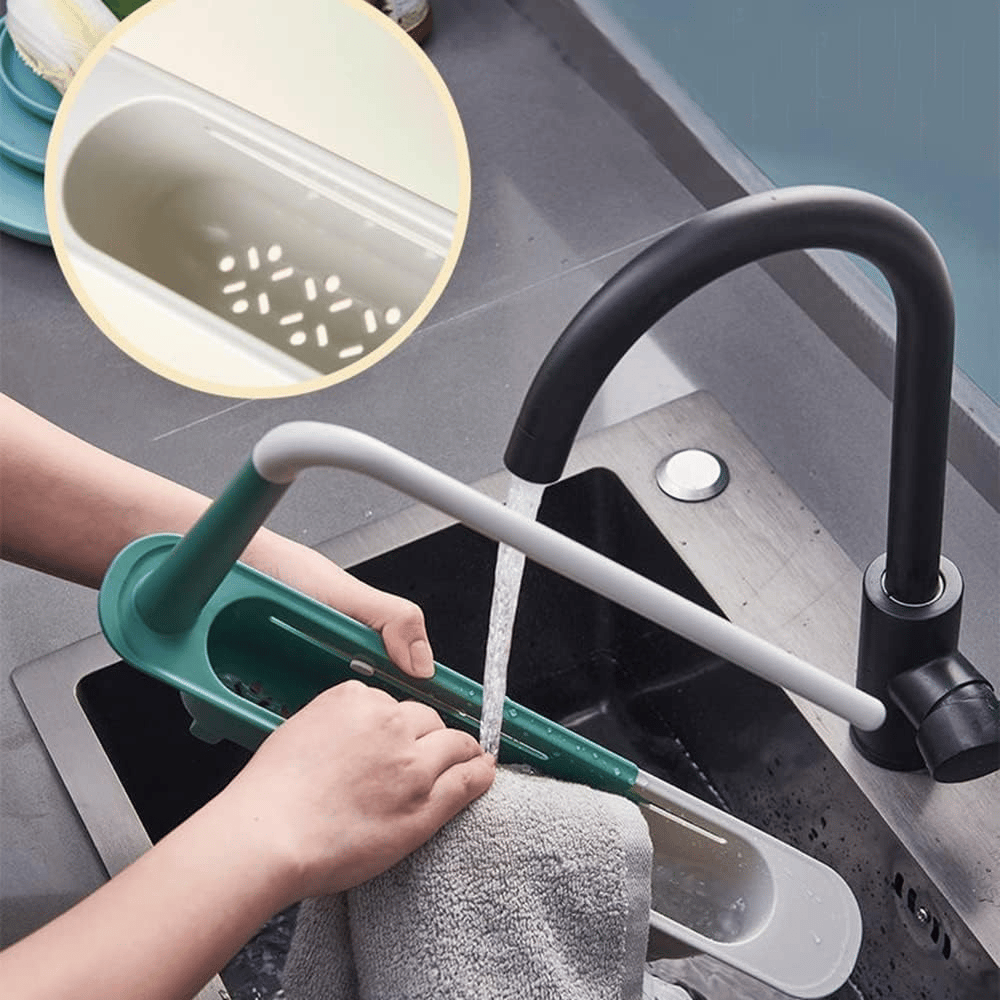 Hands rinsing the green telescopic sink rack under a tap showing drainage openings