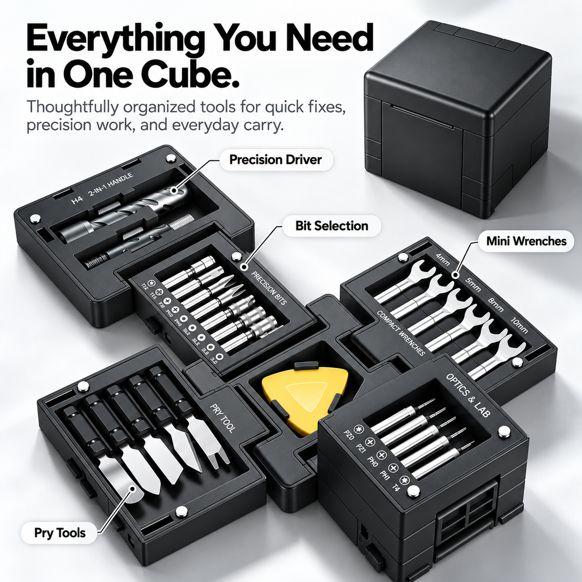 Fully opened black modular tool kit showing separated trays of precision screwdriver bits, miniature wrenches, pry tools and the storage cube