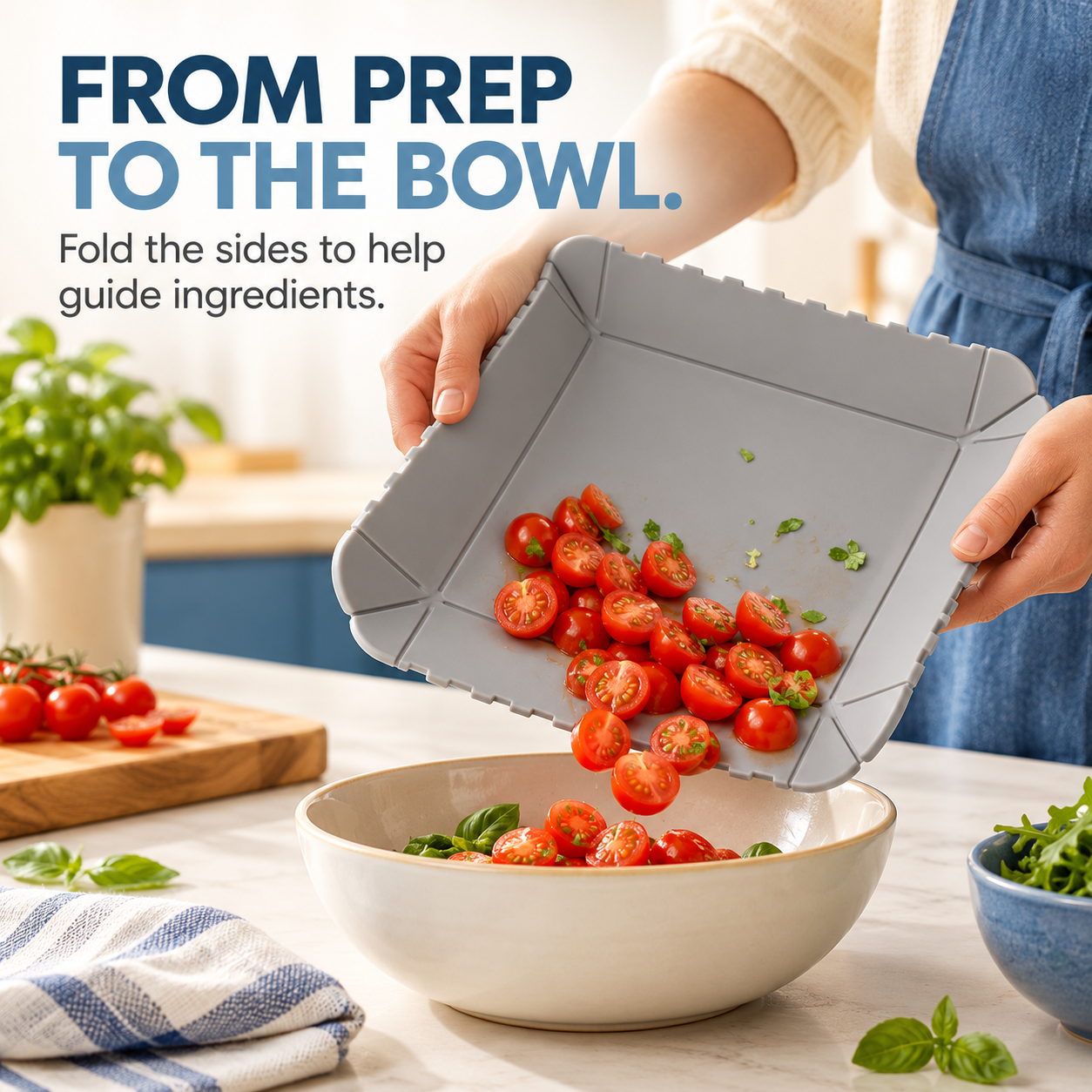 Gray folding mat guiding chopped tomatoes into a bowl