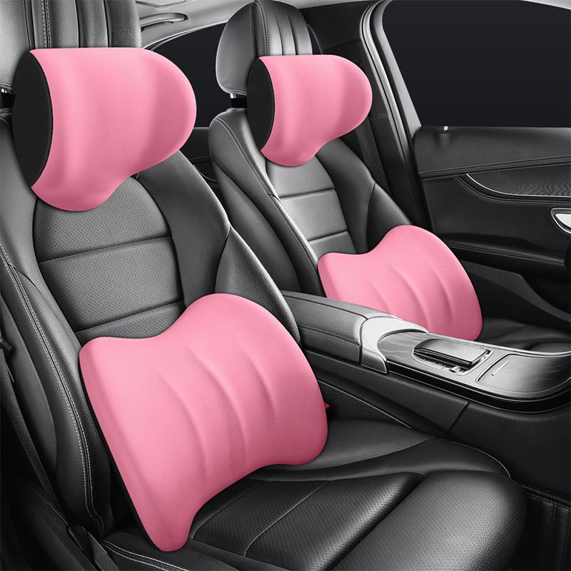 Pink ergonomic headrest and lumbar cushion set installed in vehicle