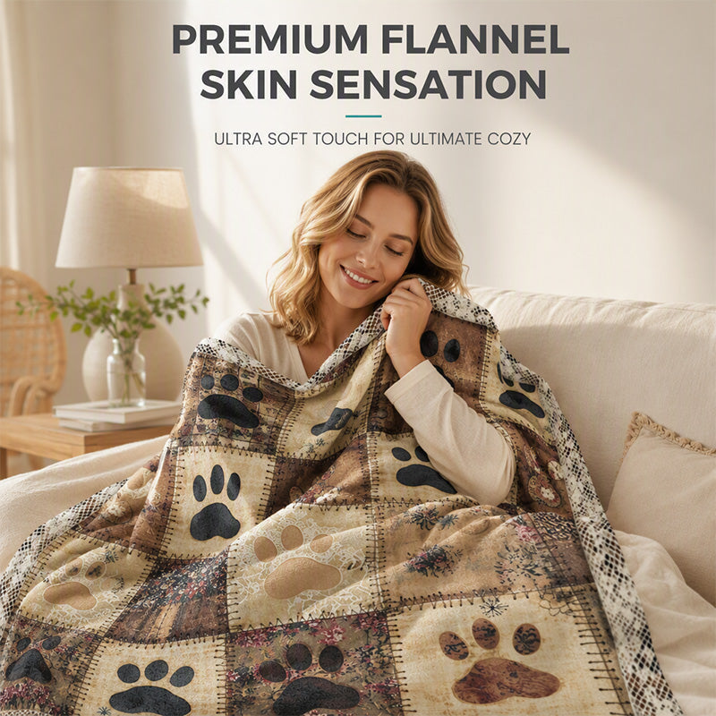 Soft flannel paw print blanket wrapped around woman on sofa