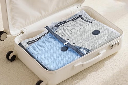Compressed travel vacuum bags packed neatly into a suitcase
